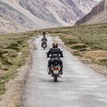 Motorradfahrer auf einer Straße in der Wildnis.